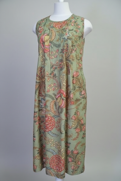Green floral dress on a mannequin against a plain background