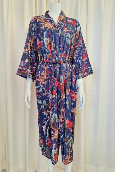Floral patterned jumpsuit on a mannequin against a white curtain background
