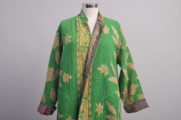 A green floral vintage hand stitched reversible cotton coat with kantha stitching, displayed on a model.