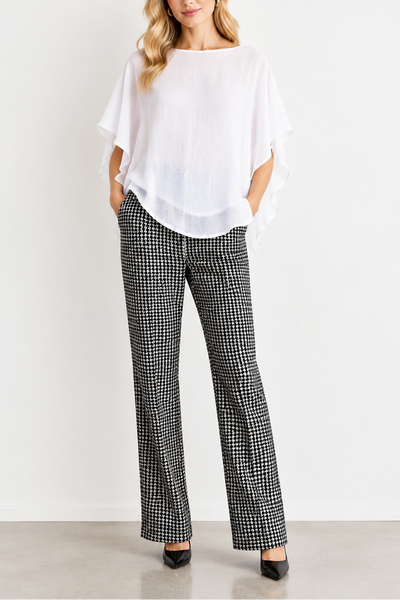 A pair of Italian stretch pants with a dogstooth pattern, displayed on a mannequin with a white top and black-and-white checkered pants.