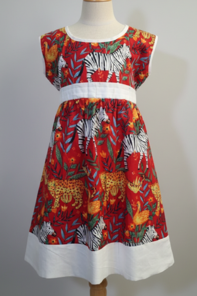Colorful dress with animal print on a mannequin against a white background