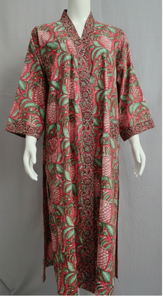 Red patterned dress on a mannequin against a green screen background