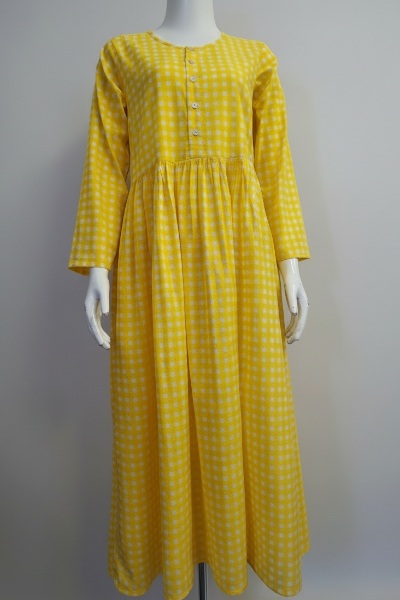 Yellow checkered dress on a mannequin against a gray background