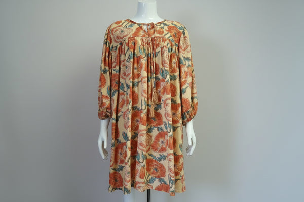Floral patterned dress on a mannequin against a plain background