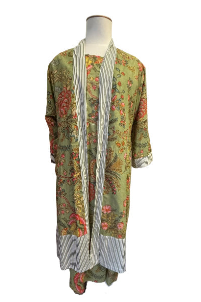 Mannequin wearing a floral and striped long garment on a white background