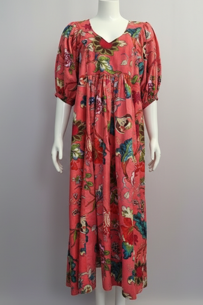 Red floral dress on a mannequin against a gray background