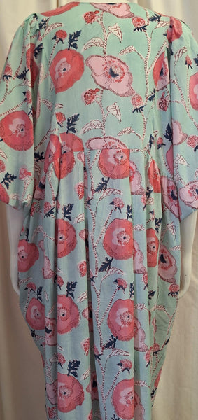 A short-sleeve kaftan dress featuring a light mint green background with a large pink floral print and delicate black vine details.