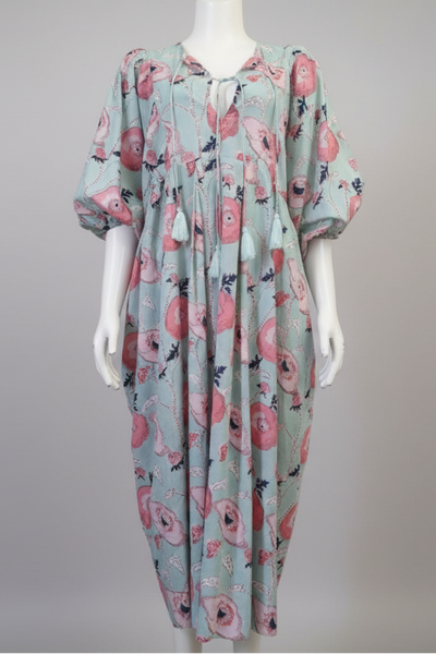 Floral patterned dress on a mannequin against a gray background