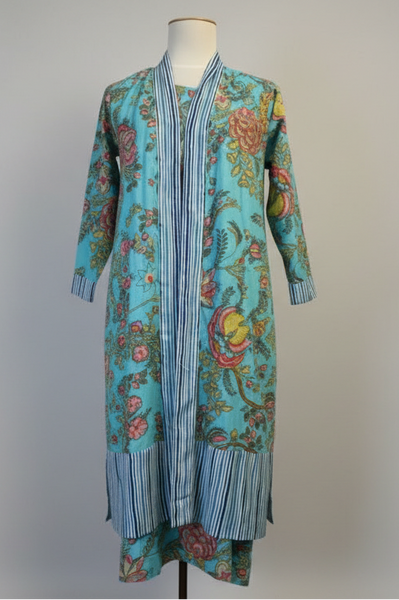 Turquoise floral and striped dress on a mannequin against a white background