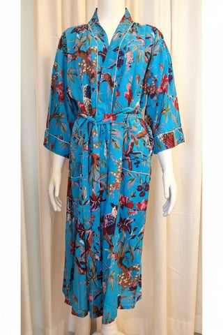 A turquoise maxi robe with a floral pattern, white piping on pockets, cuffs, and front band, displayed on a mannequin.