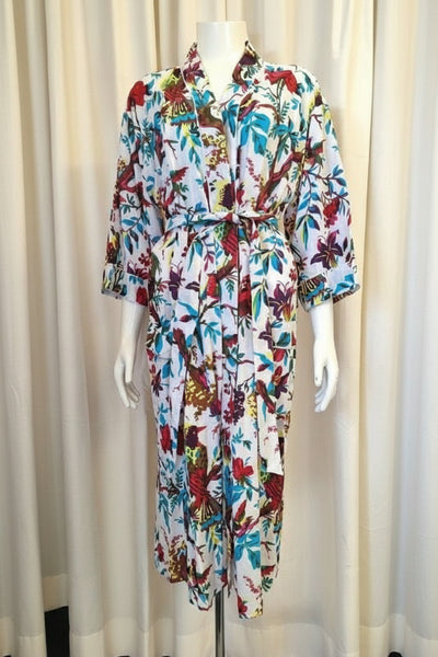 Colorful floral dress on a mannequin against a plain background