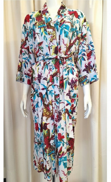 Colorful floral dress on a mannequin against a beige curtain background